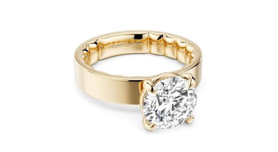 A yellow gold solitaire engagement ring with a wide band, available at GMG Jewellers.