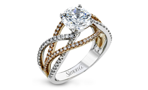 A two-tone gold split shank engagement ring with a round center stone, available at GMG Jewellers.